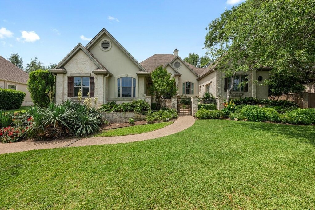 11903 Colleyville Dr, Bee Cave, TX 78738 - ranch-style house featuring fence, a chimney, a front lawn, and stucco siding