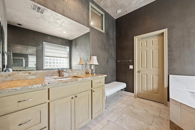 bathroom with vanity and visible vents