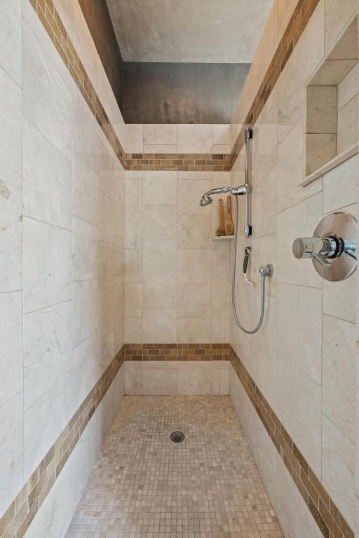 bathroom with a tile shower