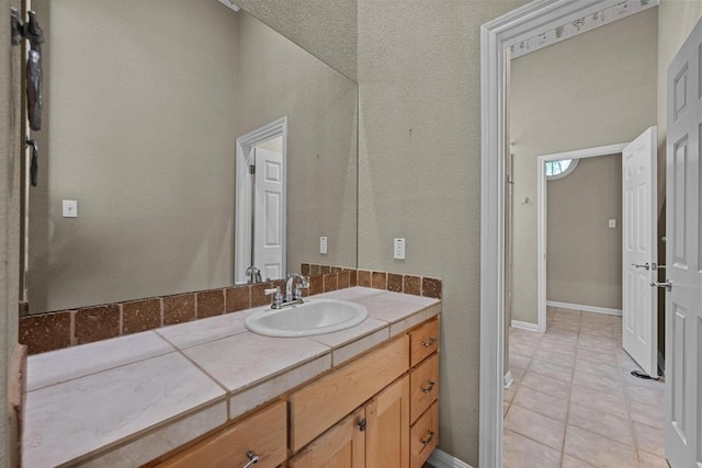 bathroom with tile patterned floors and vanity