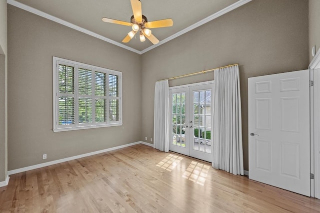 unfurnished room with crown molding, french doors, a ceiling fan, baseboards, and wood finished floors