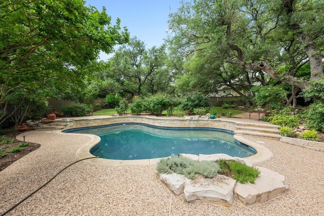 outdoor pool featuring a fenced backyard