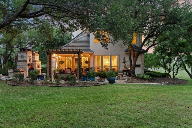 109 Lost Spur, Horseshoe Bay, TX 78657 - back of house featuring a patio, a yard, a fireplace, a pergola, and stucco siding