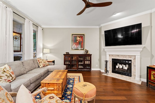109 Lost Spur, Horseshoe Bay, TX 78657 - living room with crown molding, a ceiling fan, baseboards, a fireplace with flush hearth, and wood finished floors