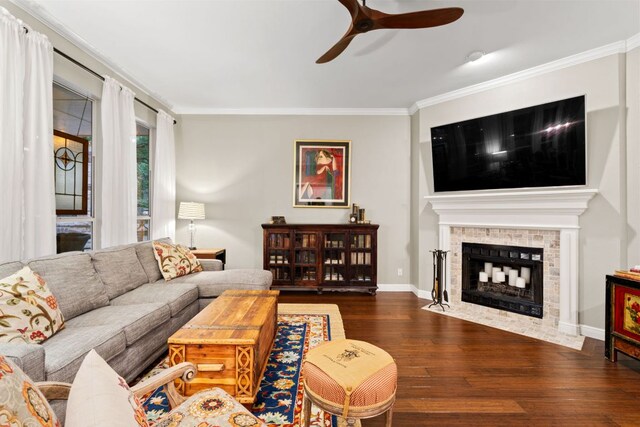 109 Lost Spur, Horseshoe Bay, TX 78657 - living room with a ceiling fan, wood finished floors, ornamental molding, a fireplace, and baseboards