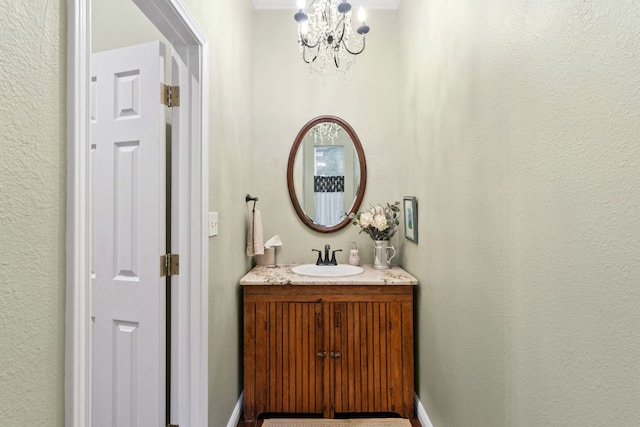 109 Lost Spur, Horseshoe Bay, TX 78657 - bathroom with an inviting chandelier, baseboards, and vanity
