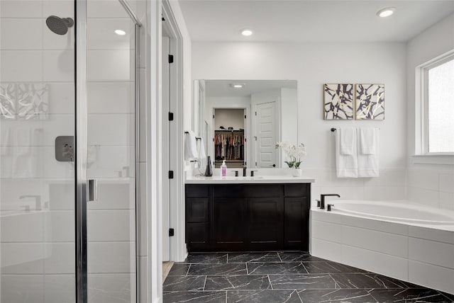 full bath with vanity, marble finish floor, recessed lighting, a shower stall, and a garden tub
