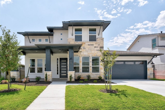 view of front facade featuring a garage, a front lawn, fence, stone siding, and concrete driveway