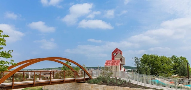 view of home's community featuring fence