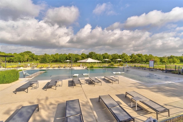 community pool with fence and a patio