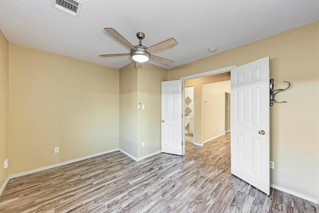 empty room with baseboards, ceiling fan, and wood finished floors