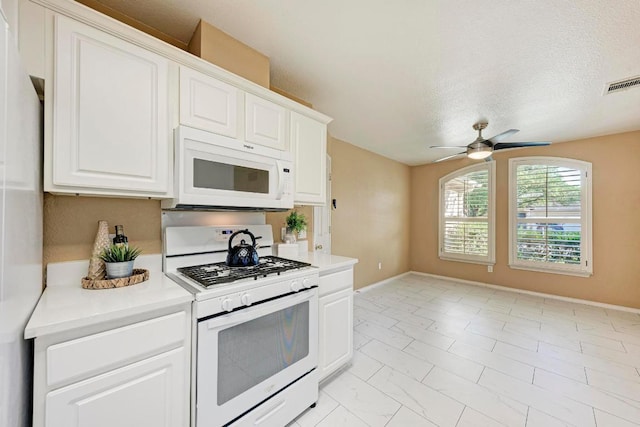 kitchen featuring ceiling fan, visible vents, light countertops, white cabinets, and white appliances