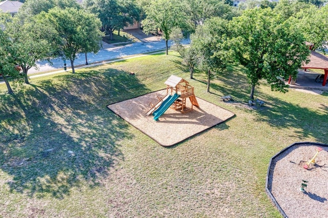 view of home's community featuring a lawn and playground community