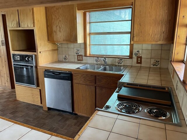401 County Road 128, Burnet, TX 78611 - kitchen featuring backsplash, stainless steel dishwasher, a sink, tile counters, and oven