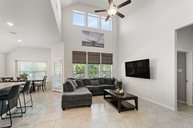living area with plenty of natural light, a ceiling fan, visible vents, and high vaulted ceiling
