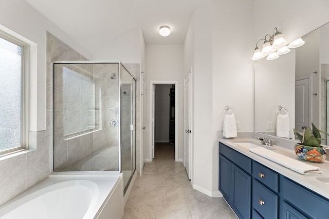 full bathroom featuring double vanity, a shower stall, a sink, and a bath