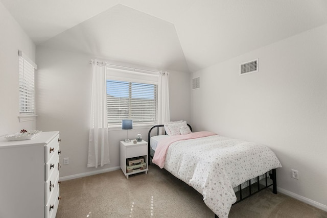 bedroom with visible vents, baseboards, lofted ceiling, and light carpet