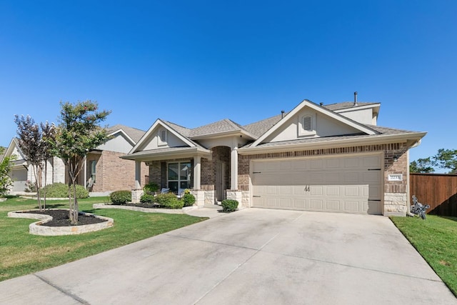 view of front facade with fence, a garage, driveway, and a front lawn
