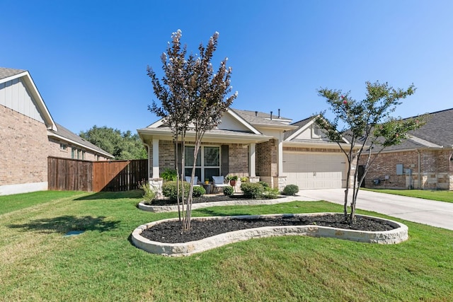 view of front facade featuring driveway, a front yard, brick siding, fence, and an attached garage