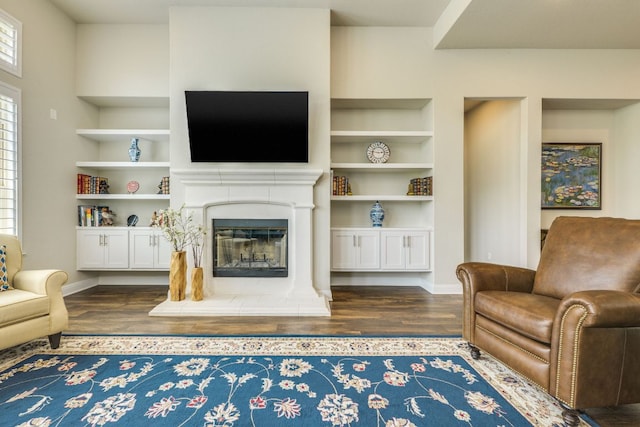 207 Vista Village Cv, Lakeway, TX 78738 - living area with wood finished floors, built in shelves, and a glass covered fireplace
