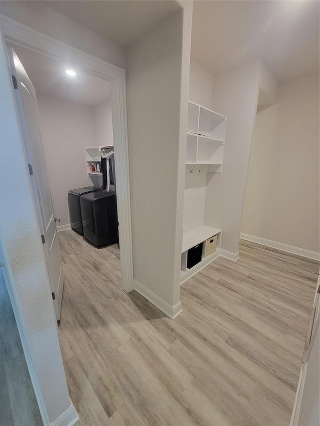 mudroom featuring light wood-style floors and baseboards