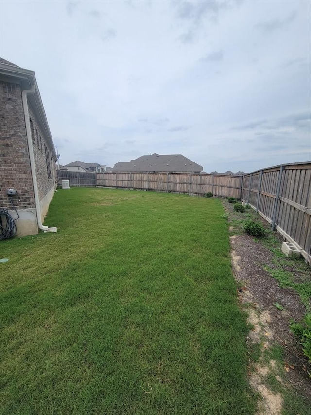 view of yard with a fenced backyard