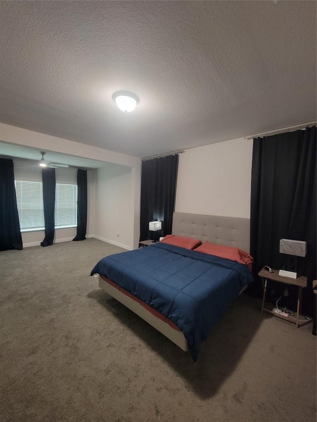 bedroom with carpet floors and a textured ceiling