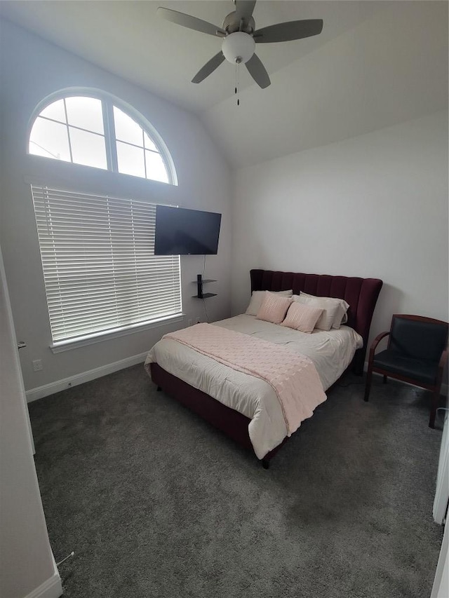 carpeted bedroom featuring baseboards, ceiling fan, and vaulted ceiling