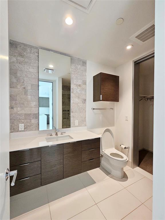 bathroom with vanity, tile patterned flooring, toilet, and visible vents
