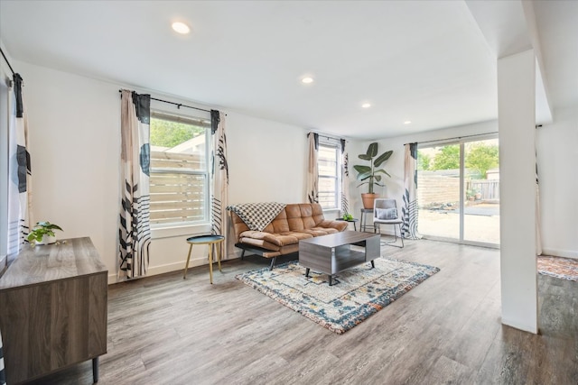 living room featuring baseboards, recessed lighting, and wood finished floors
