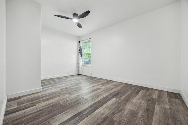 empty room with a ceiling fan, baseboards, and wood finished floors