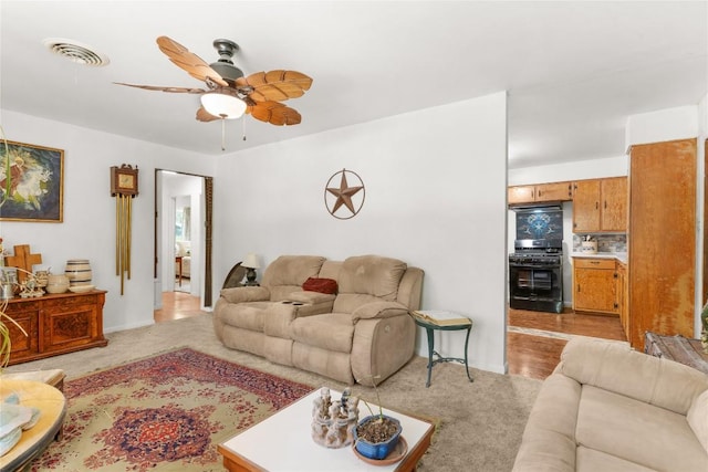 607 Gilmore St, Taylor, TX 76574 - living room with visible vents, ceiling fan, and light colored carpet