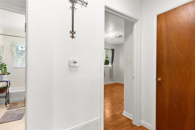607 Gilmore St, Taylor, TX 76574 - corridor featuring baseboards and wood finished floors
