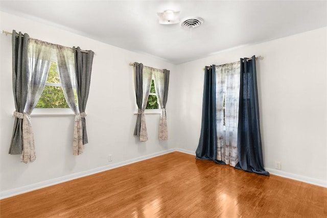 607 Gilmore St, Taylor, TX 76574 - empty room featuring plenty of natural light, wood finished floors, and visible vents