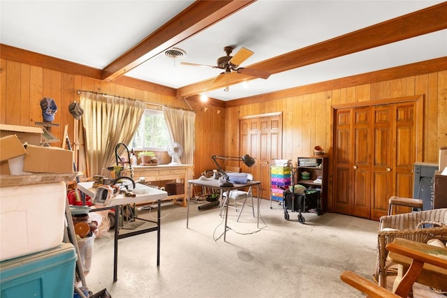 607 Gilmore St, Taylor, TX 76574 - living area with wooden walls, carpet flooring, a ceiling fan, beamed ceiling, and visible vents