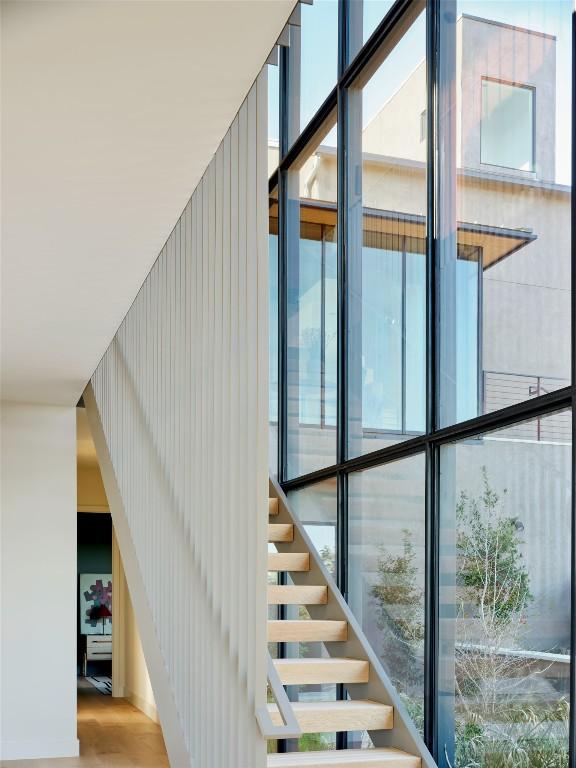 2405 Deer Pass, Austin, TX 78746 - stairs featuring a wealth of natural light and wood finished floors