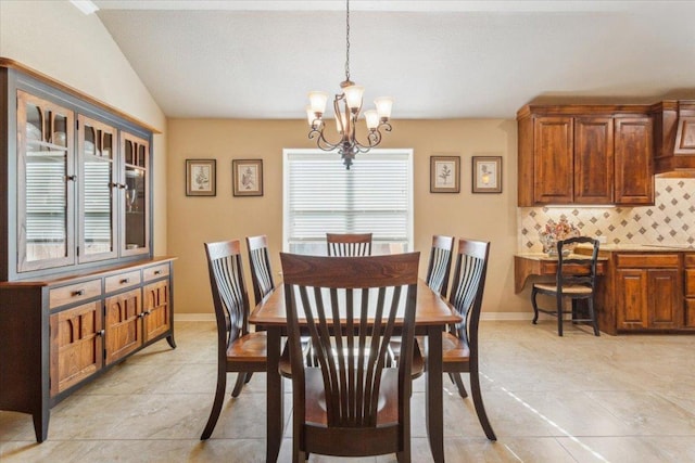dining area featuring baseboards, a chandelier, light tile patterned floors, and vaulted ceiling