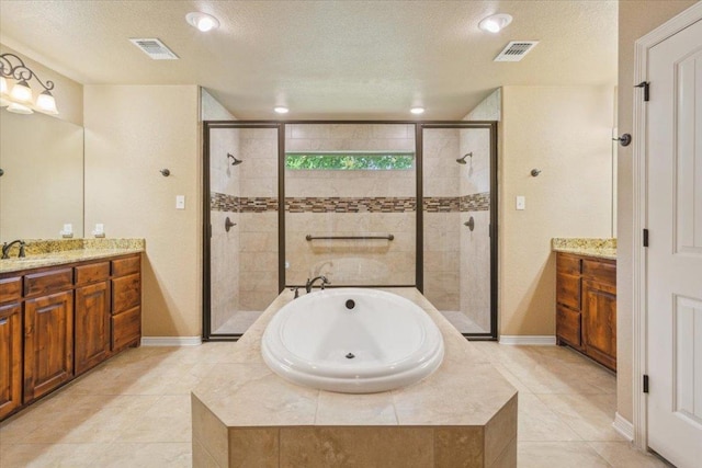 bathroom featuring a bath, visible vents, a stall shower, vanity, and tile patterned floors