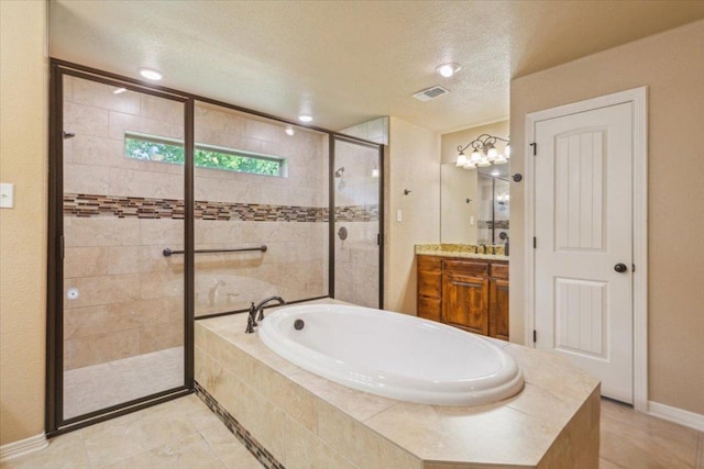 bathroom featuring vanity, a textured ceiling, visible vents, a bath, and a stall shower