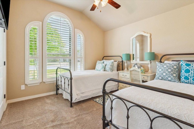 bedroom with carpet floors, multiple windows, and vaulted ceiling