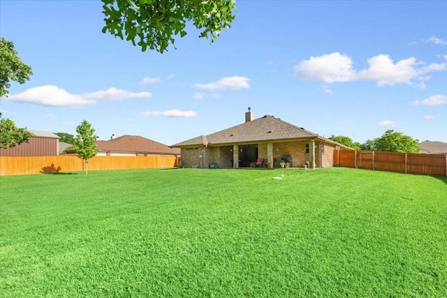 view of yard with a fenced backyard