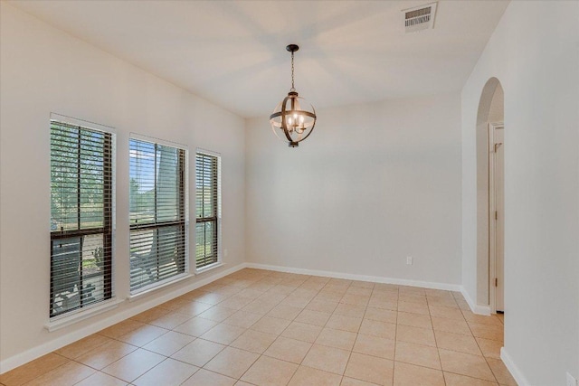 182 Lone Tree Holw, Buda, TX 78610 - unfurnished room featuring a chandelier, arched walkways, light tile patterned floors, and baseboards