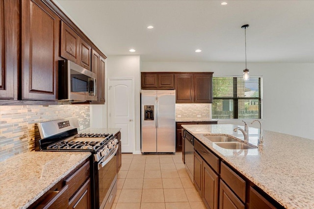 182 Lone Tree Holw, Buda, TX 78610 - kitchen with appliances with stainless steel finishes, a sink, tasteful backsplash, recessed lighting, and hanging light fixtures