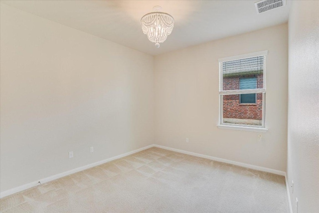 182 Lone Tree Holw, Buda, TX 78610 - empty room featuring light carpet, a chandelier, and baseboards