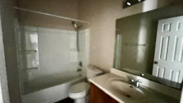 bathroom with toilet, bathtub / shower combination, and vanity