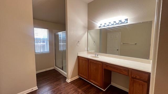 1616 Bowerton Dr, Austin, TX 78754 - bathroom featuring vanity, a shower stall, and wood finished floors