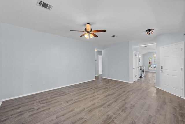 unfurnished living room featuring baseboards, a ceiling fan, wood finished floors, and visible vents