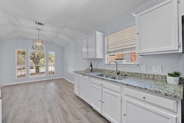 kitchen featuring visible vents, baseboards, light wood-type flooring, white cabinetry, and a sink