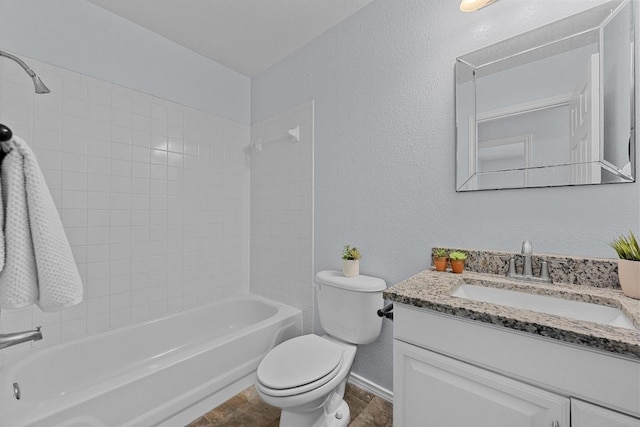 full bathroom featuring vanity, baseboards, toilet, a textured wall, and tub / shower combination