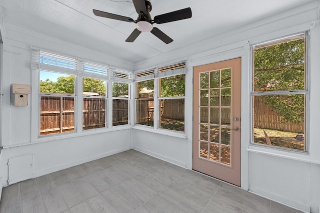 unfurnished sunroom with a ceiling fan